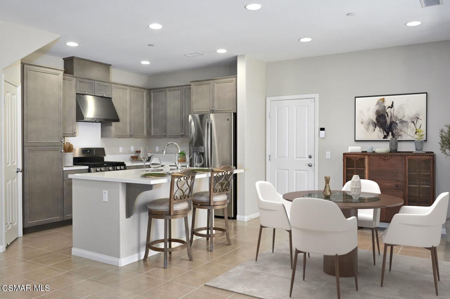 186 Stonegate Road Camarillo, CA 93010 - Photo 5 of 34 a kitchen with a table chairs refrigerator and microwave