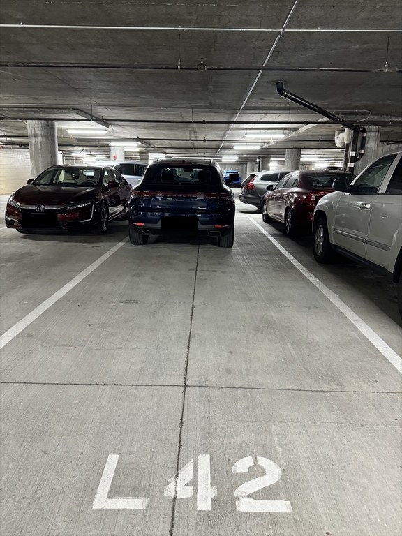 a view of parking garage with cars