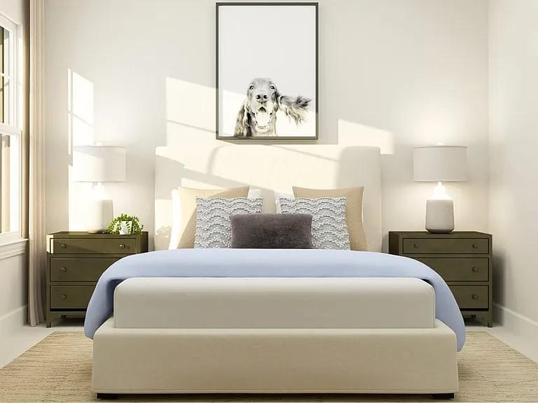 a bedroom with a bed and a painting on the wall