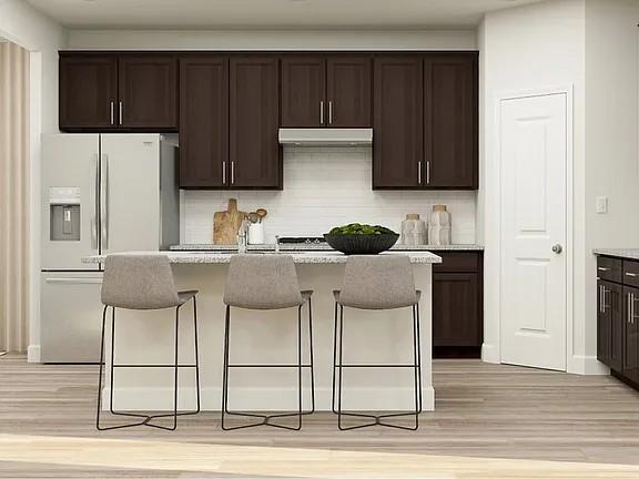 208 Eden View Bend Raleigh, NC 27610 - Photo 5 of 14 a kitchen with stainless steel appliances kitchen island granite countertop a cabinets and a stove top oven