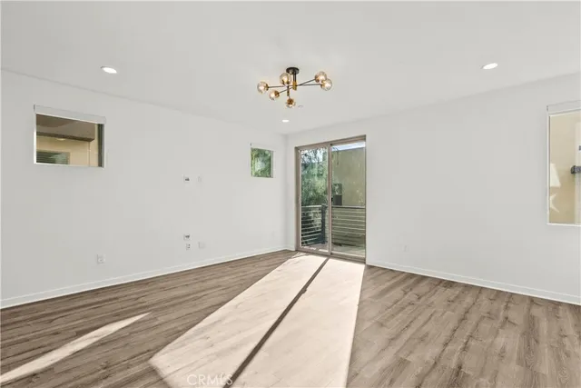 a view of an empty room with a kitchen
