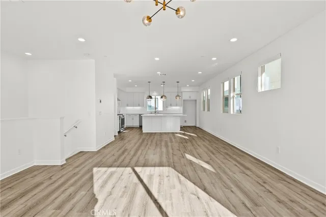 a kitchen with stainless steel appliances granite countertop a stove and wooden floor