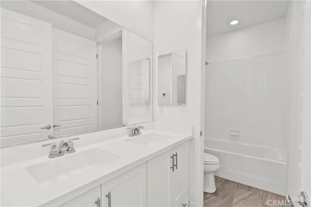 a view of a kitchen with wooden floor and a sink