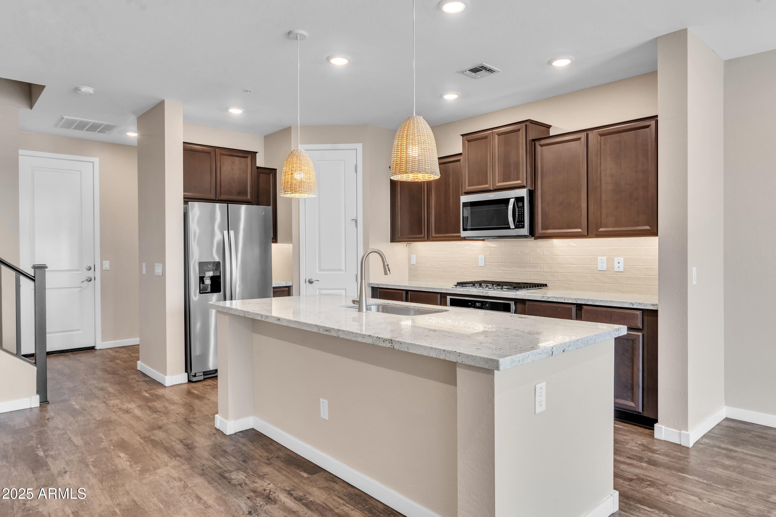 3855 South McQueen Road, Unit 98 Chandler, AZ 85286 - Photo 9 of 41 a kitchen with kitchen island stainless steel appliances a refrigerator and a microwave