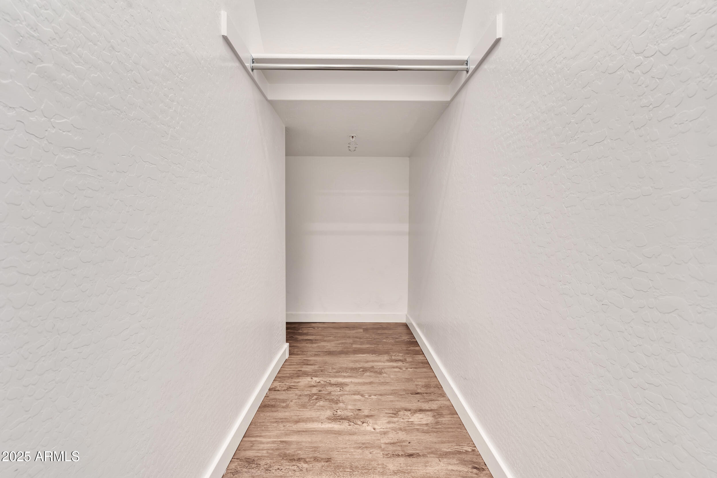3855 South McQueen Road, Unit 98 Chandler, AZ 85286 - Photo 11 of 41 a view of a hallway with wooden floor