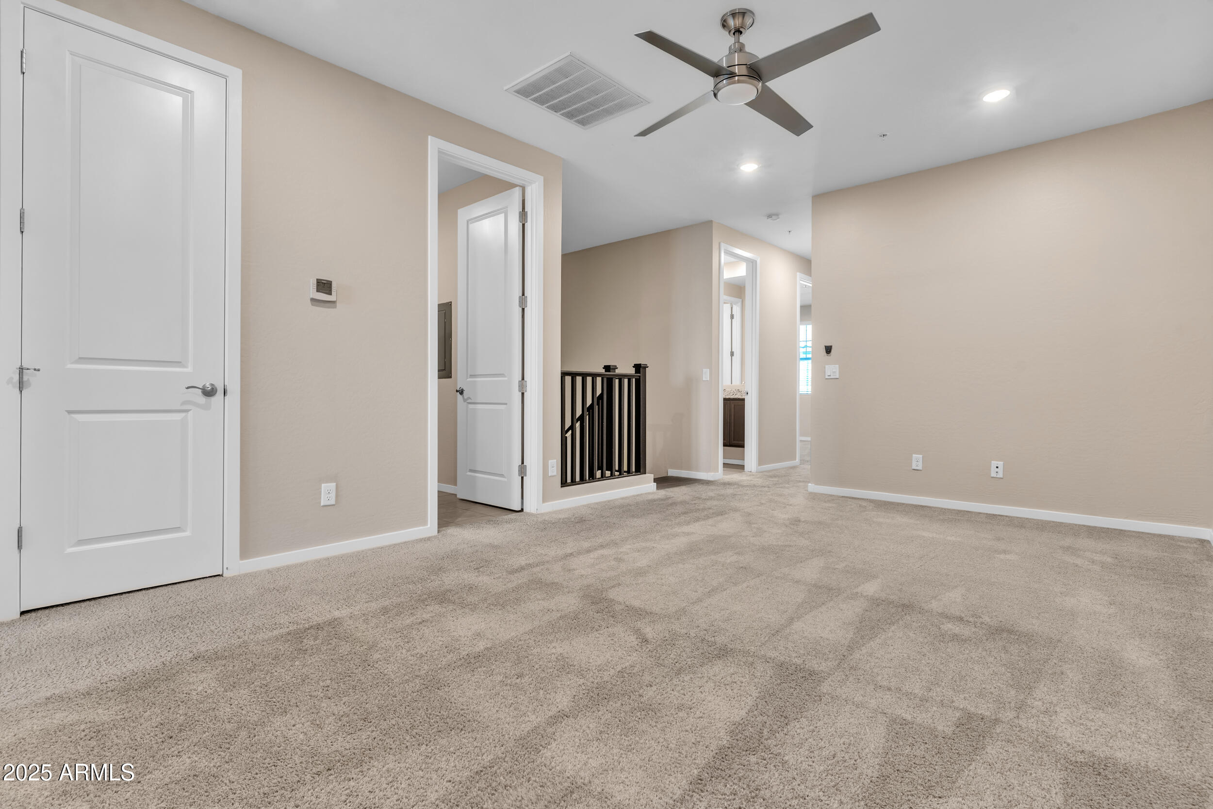 3855 South McQueen Road, Unit 98 Chandler, AZ 85286 - Photo 24 of 41 an empty room with ceiling fan and windows