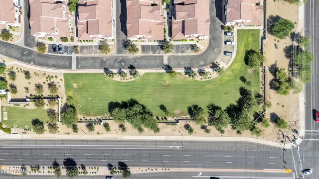 an aerial view of residential houses with outdoor space and ocean view