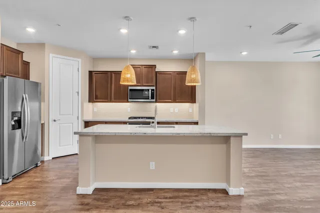 a view of empty room with wooden floor and a ceiling fan