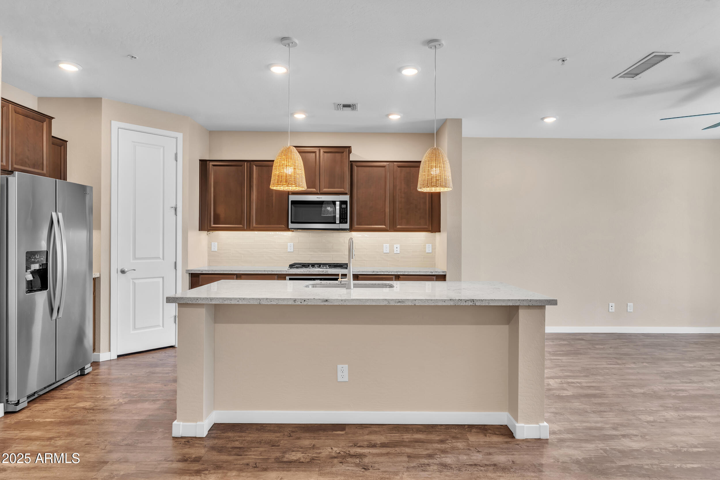 3855 South McQueen Road, Unit 98 Chandler, AZ 85286 - Photo 8 of 41 a kitchen with kitchen island stainless steel appliances a sink a refrigerator and a stove