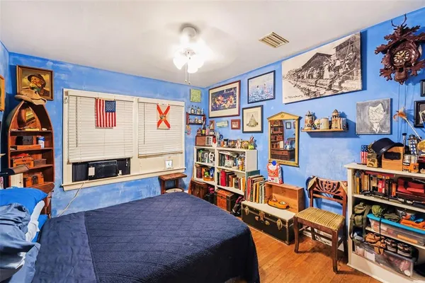 a living room with furniture a rug and a bookshelf