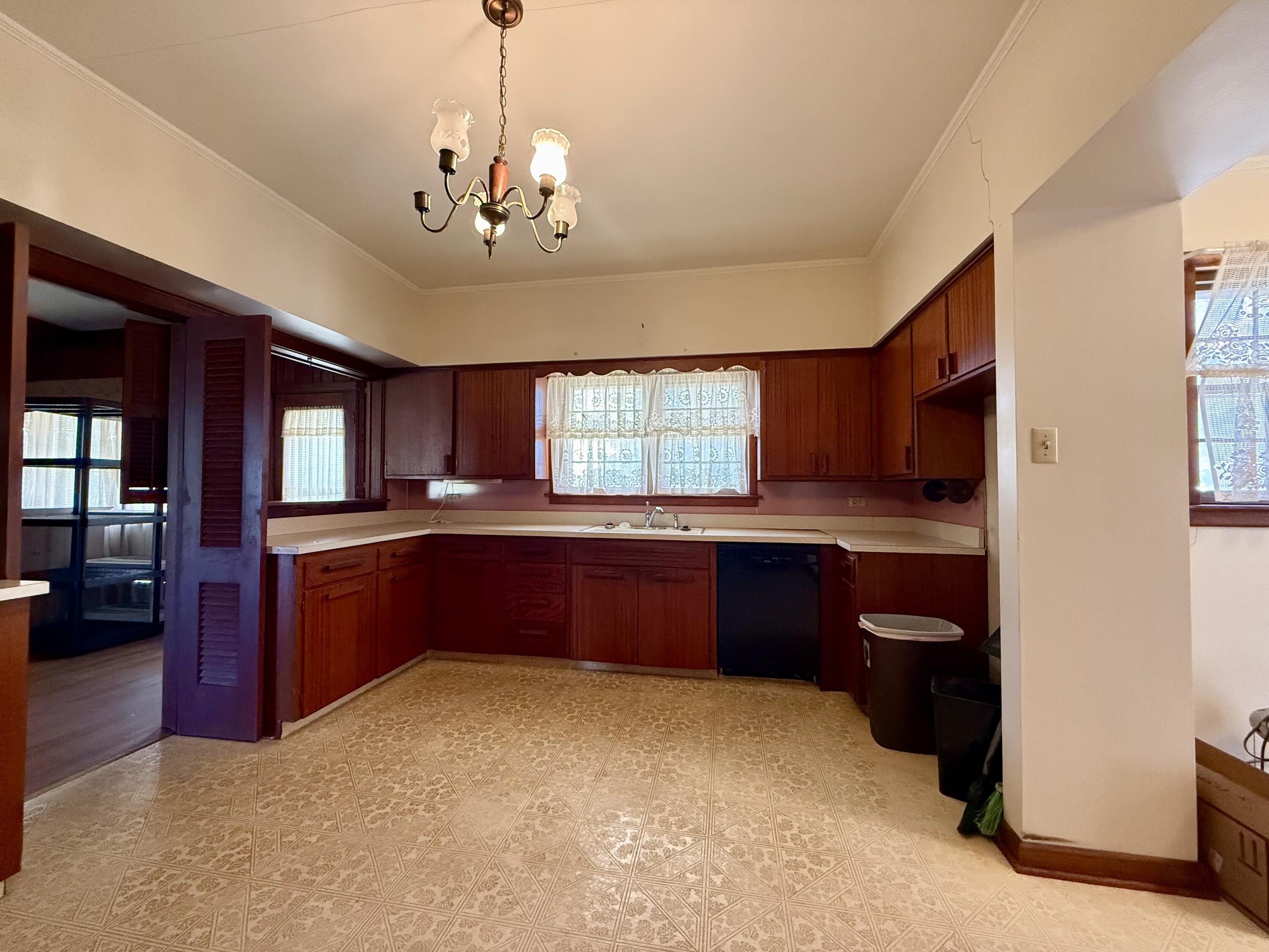 321 10th Street Memphis, TX 79245 - Photo 11 of 33 a kitchen with granite countertop a refrigerator and cabinets