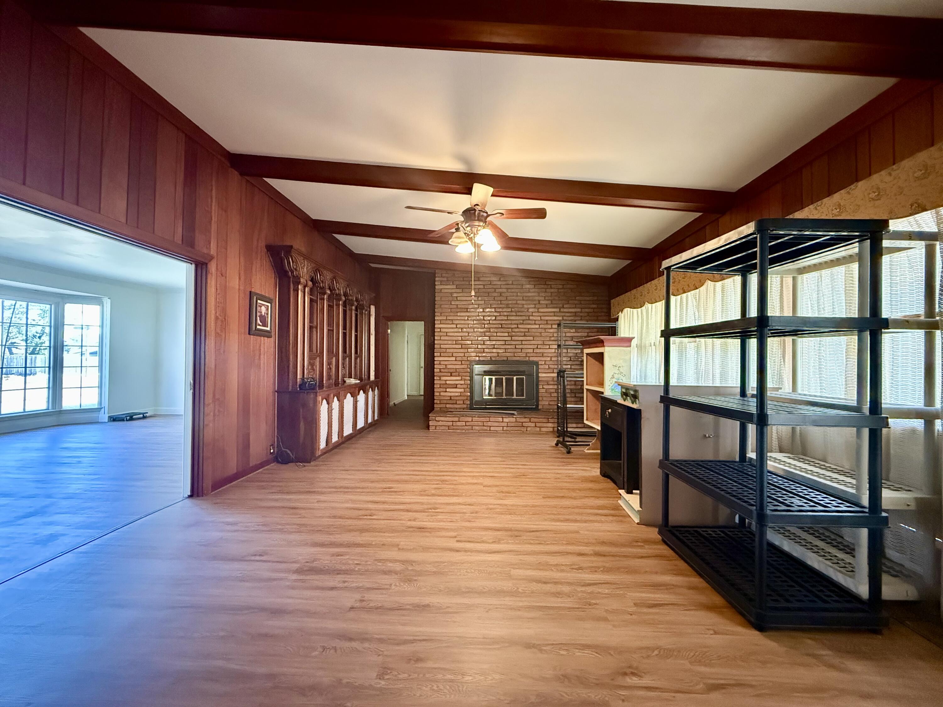 321 10th Street Memphis, TX 79245 - Photo 12 of 33 a big room with wooden floors and stairs
