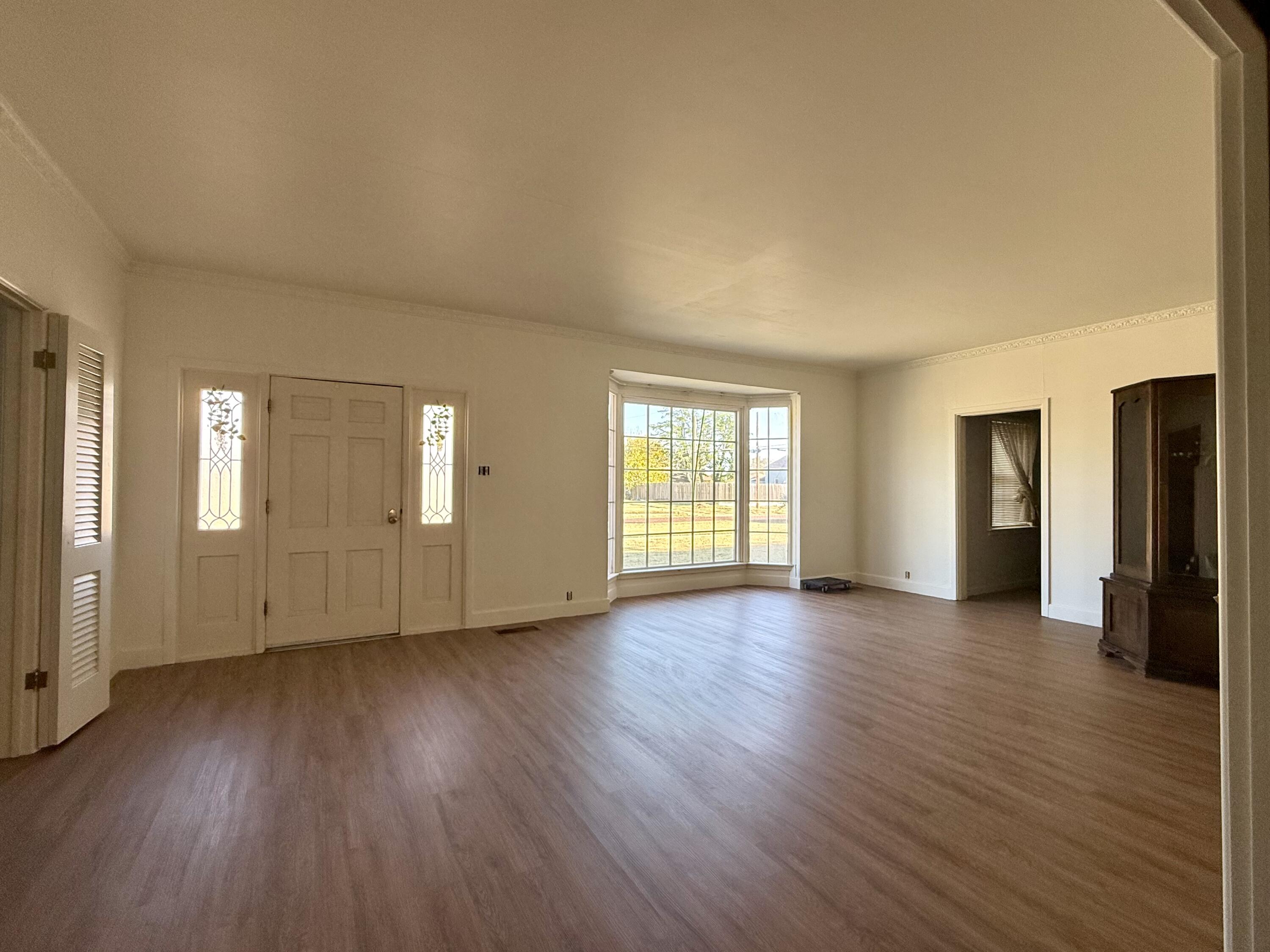 321 10th Street Memphis, TX 79245 - Photo 14 of 33 an empty room with wooden floor and windows