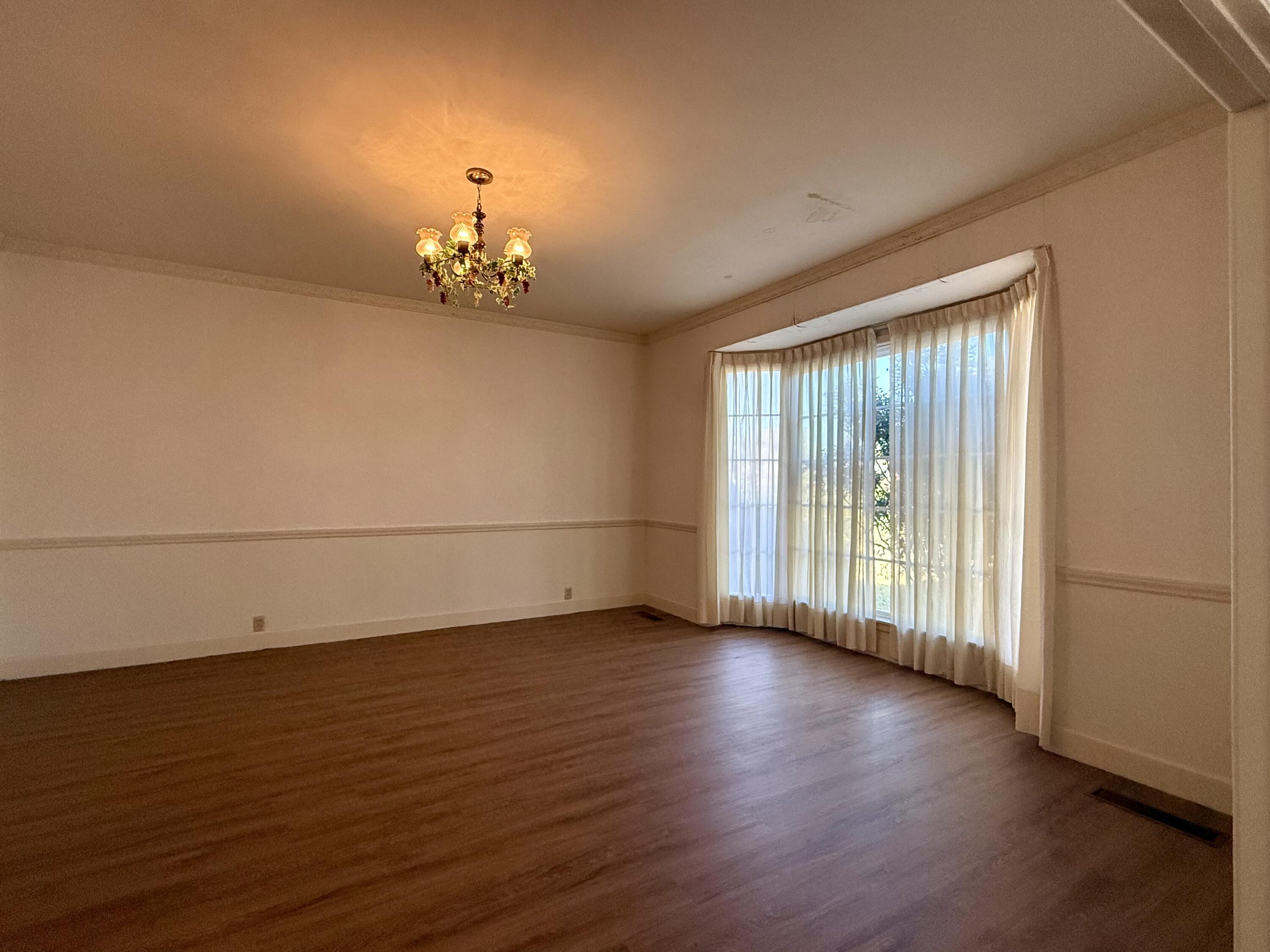 321 10th Street Memphis, TX 79245 - Photo 16 of 33 an empty room with wooden floor and windows