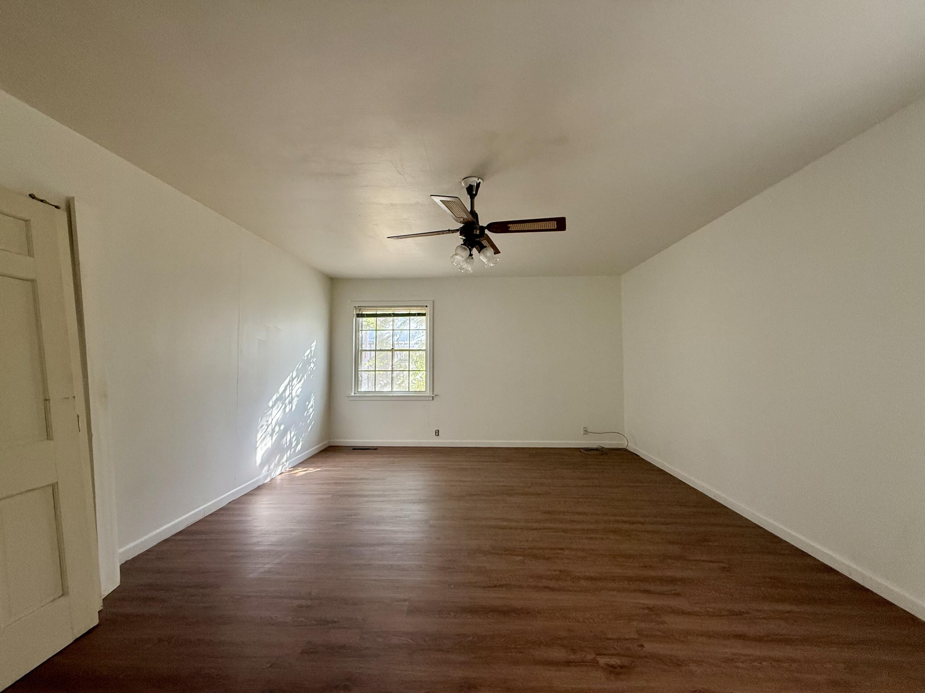 321 10th Street Memphis, TX 79245 - Photo 26 of 33 an empty room with wooden floor and windows