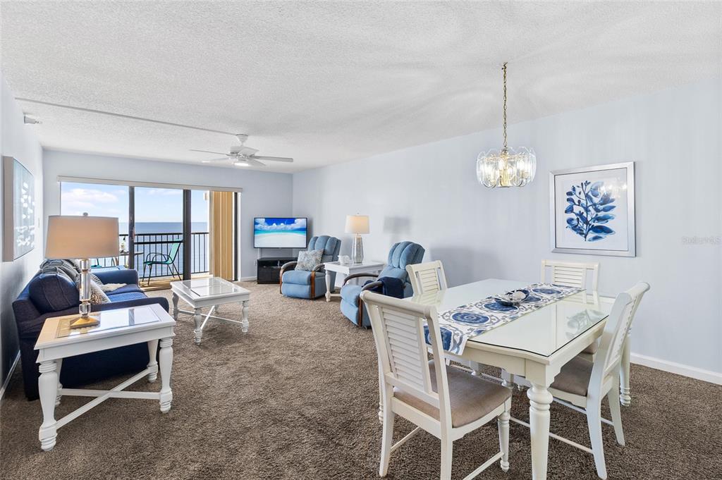 15000 Gulf Boulevard, Unit 605 Madeira Beach, FL 33708 - Photo 11 of 54 a dining room with furniture a chandelier and window
