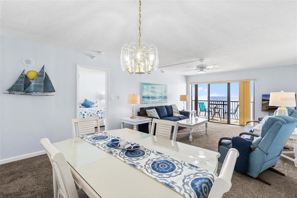 15000 Gulf Boulevard, Unit 605 Madeira Beach, FL 33708 - Photo 12 of 54 a living room with furniture and a chandelier
