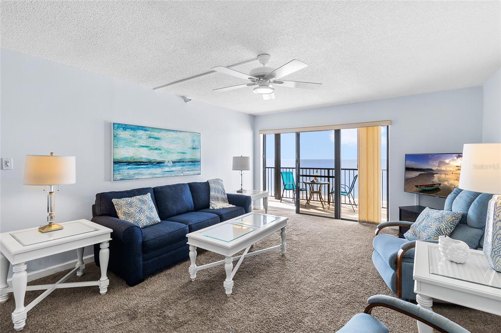 15000 Gulf Boulevard, Unit 605 Madeira Beach, FL 33708 - Photo 13 of 54 a living room with furniture and a lamp