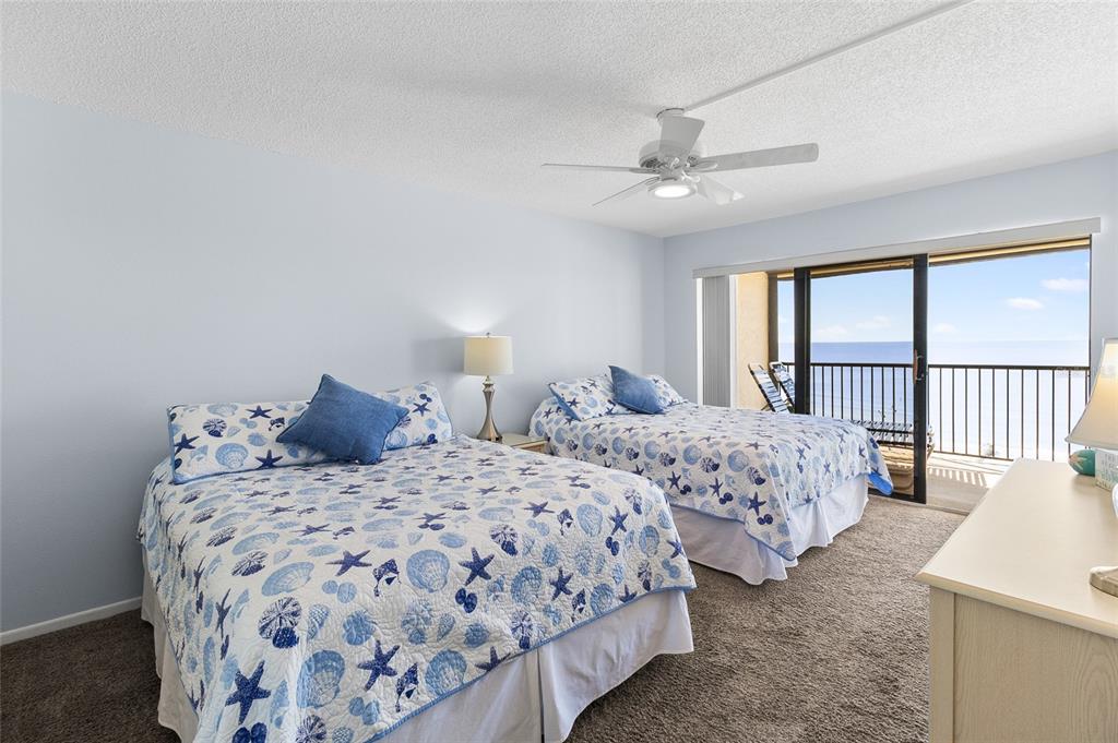 15000 Gulf Boulevard, Unit 605 Madeira Beach, FL 33708 - Photo 18 of 54 a bedroom with two beds and a large window