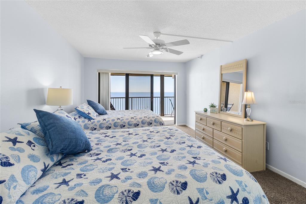 15000 Gulf Boulevard, Unit 605 Madeira Beach, FL 33708 - Photo 19 of 54 a bedroom with a large bed and a dresser