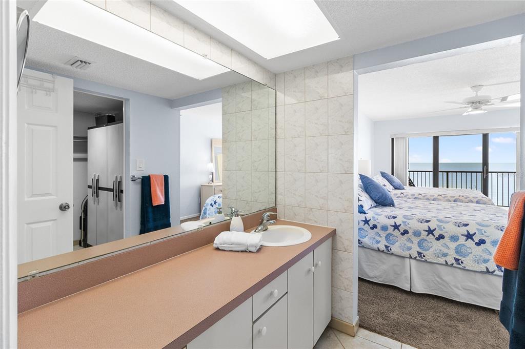 15000 Gulf Boulevard, Unit 605 Madeira Beach, FL 33708 - Photo 23 of 54 a en suite bathroom with a double vanity sink and mirror