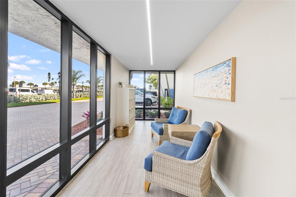 15000 Gulf Boulevard, Unit 605 Madeira Beach, FL 33708 - Photo 32 of 54 a outdoor living space with furniture and a floor to ceiling window