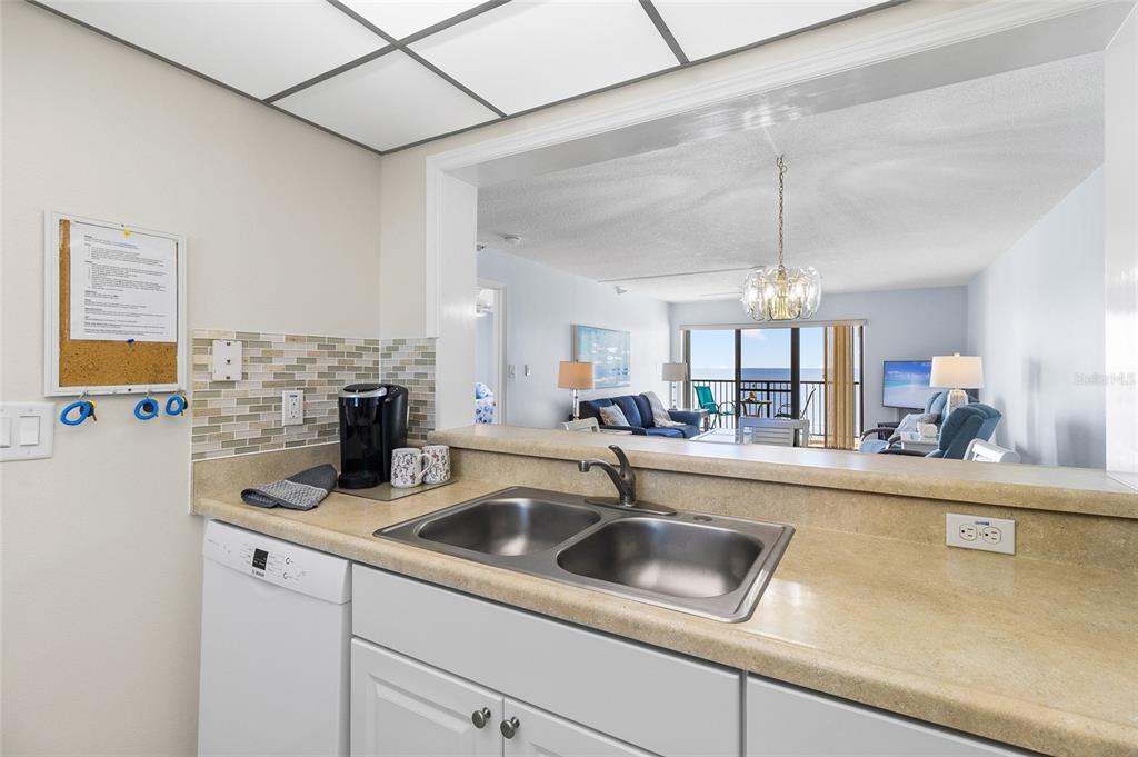 15000 Gulf Boulevard, Unit 605 Madeira Beach, FL 33708 - Photo 5 of 54 a kitchen with a sink a counter top space cabinets and stainless steel appliances