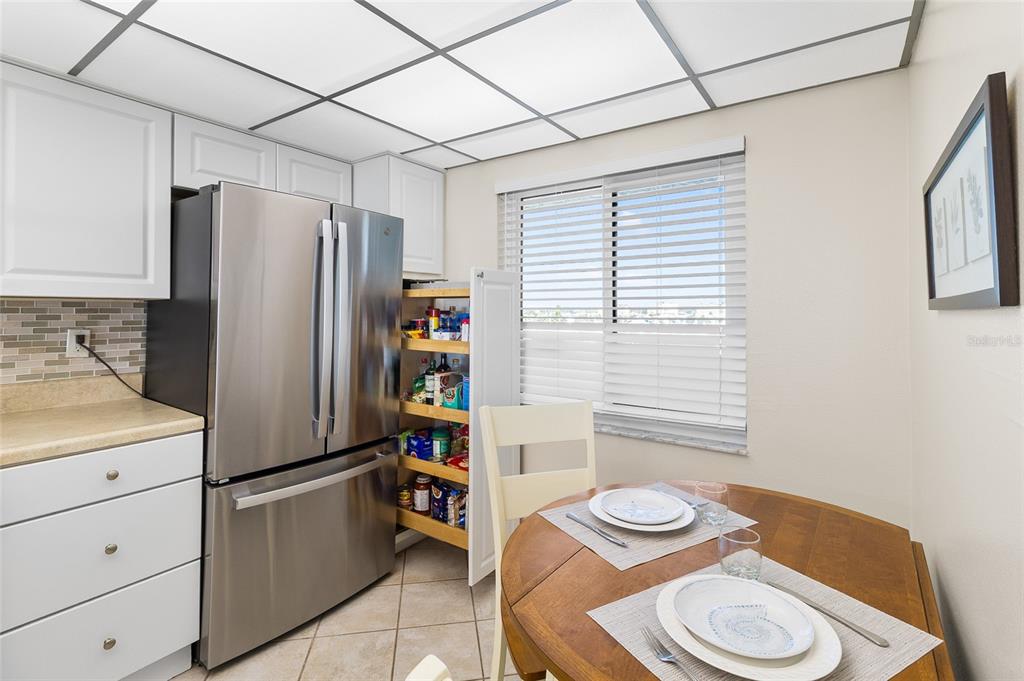 15000 Gulf Boulevard, Unit 605 Madeira Beach, FL 33708 - Photo 6 of 54 a kitchen with stainless steel appliances a refrigerator and a stove