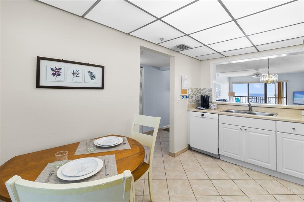 15000 Gulf Boulevard, Unit 605 Madeira Beach, FL 33708 - Photo 7 of 54 a kitchen with a sink a stove a dining table and chairs