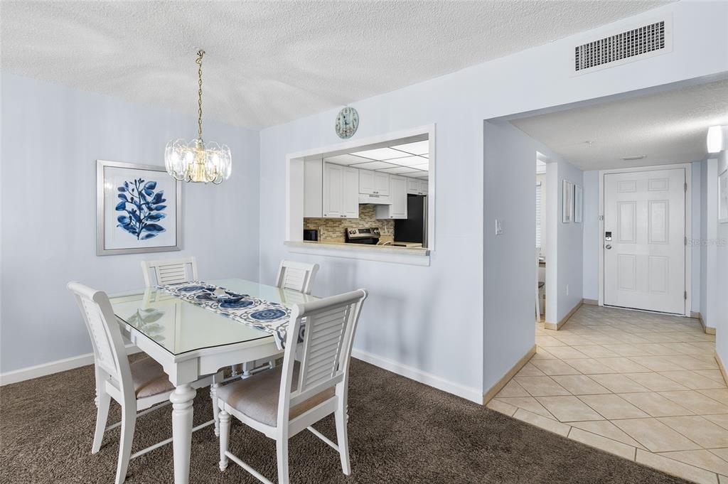 15000 Gulf Boulevard, Unit 605 Madeira Beach, FL 33708 - Photo 10 of 54 a view of a dining room and chandelier