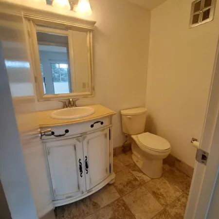 a bathroom with a sink a toilet and mirror