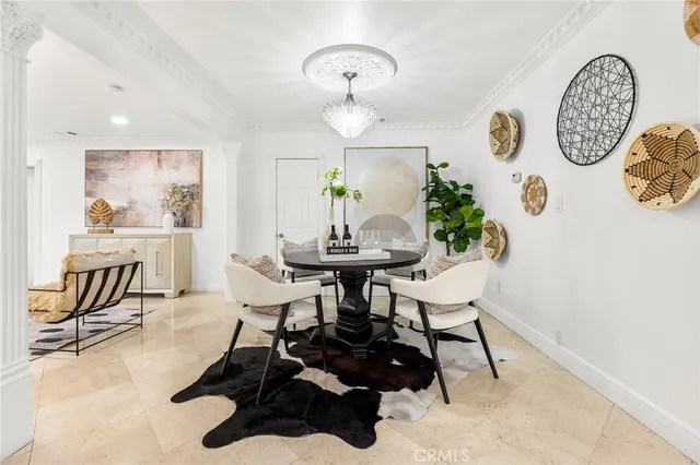 a view of a dining room with furniture and chandelier