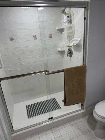 a bathroom with a shower and toilet