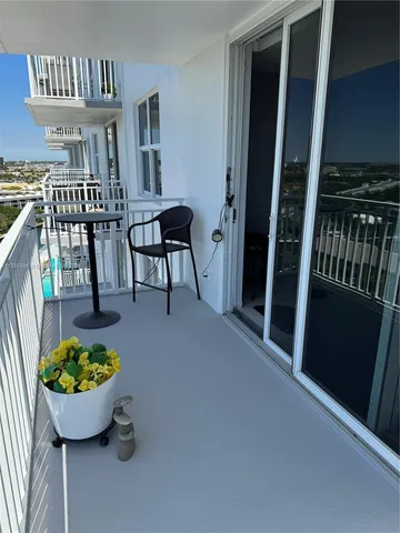 a view of an chairs and table in the balcony