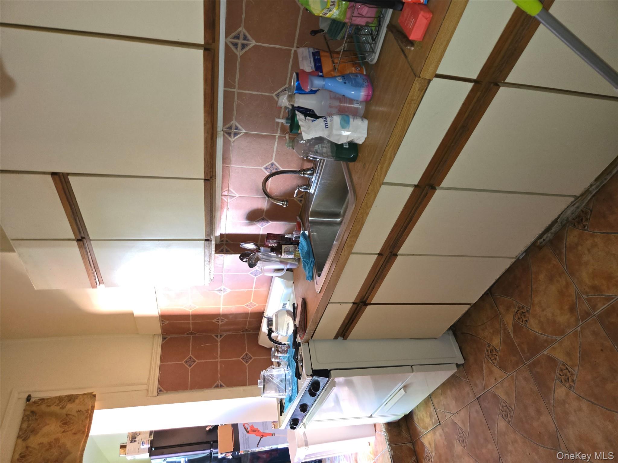 343 Rutland Road Brooklyn, NY 11225 - Photo 13 of 17 a kitchen with a sink and cabinets