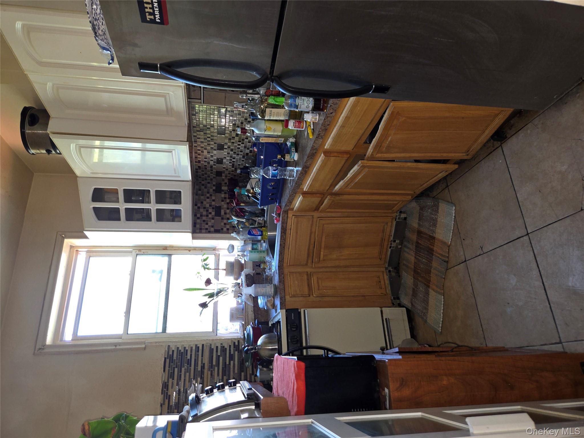 343 Rutland Road Brooklyn, NY 11225 - Photo 4 of 17 a kitchen with a sink refrigerator and cabinets