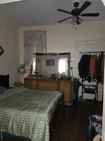 a bed sitting in a bedroom and chair