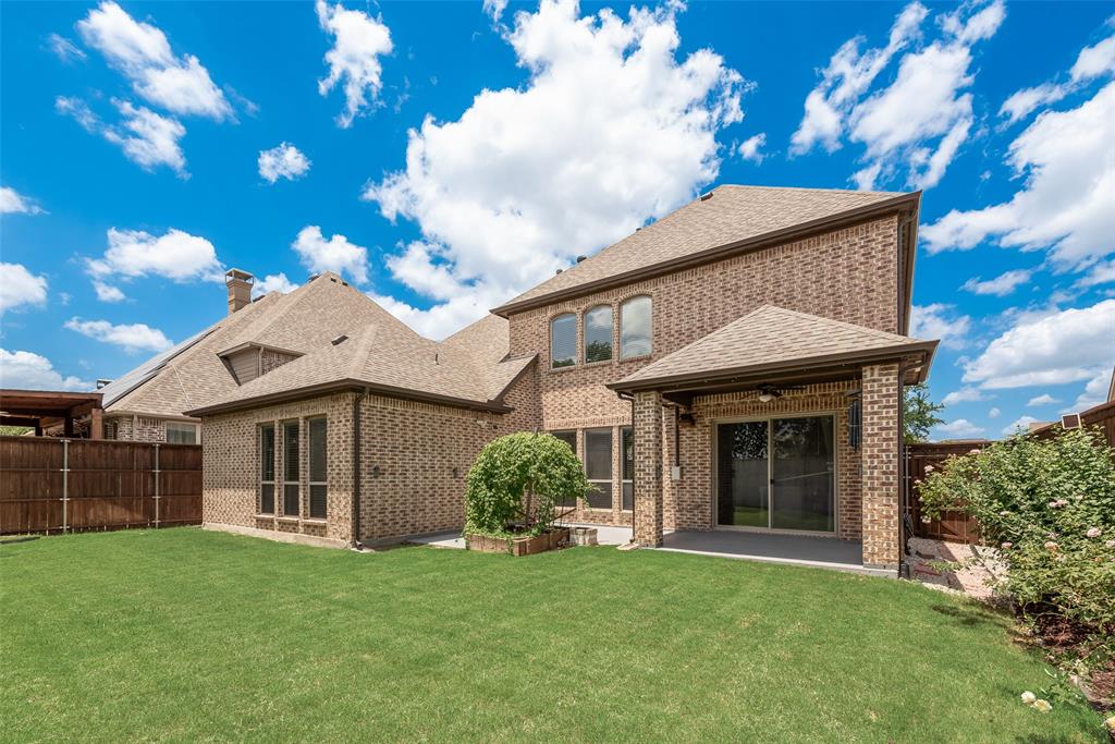 2021 Calisto Way Allen, TX 75013 - Photo 32 of 34 Expansive grassy yard complemented by a brick exterior and covered patio