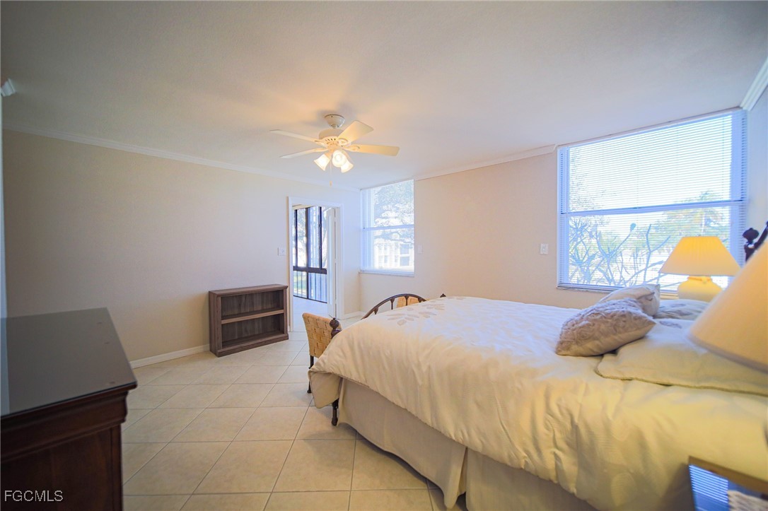 5959 Winkler Road, Unit 206 Fort Myers, FL 33919 - Photo 13 of 50 a bedroom with a bed and dresser with window