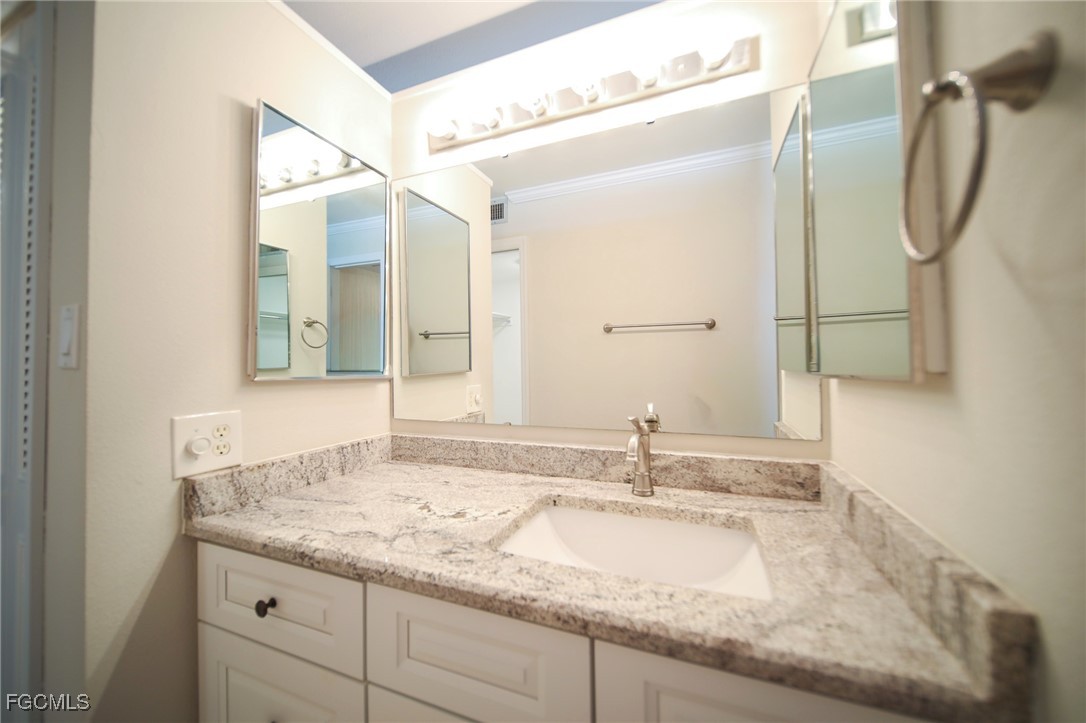 5959 Winkler Road, Unit 206 Fort Myers, FL 33919 - Photo 15 of 50 a bathroom with a granite countertop sink and a mirror