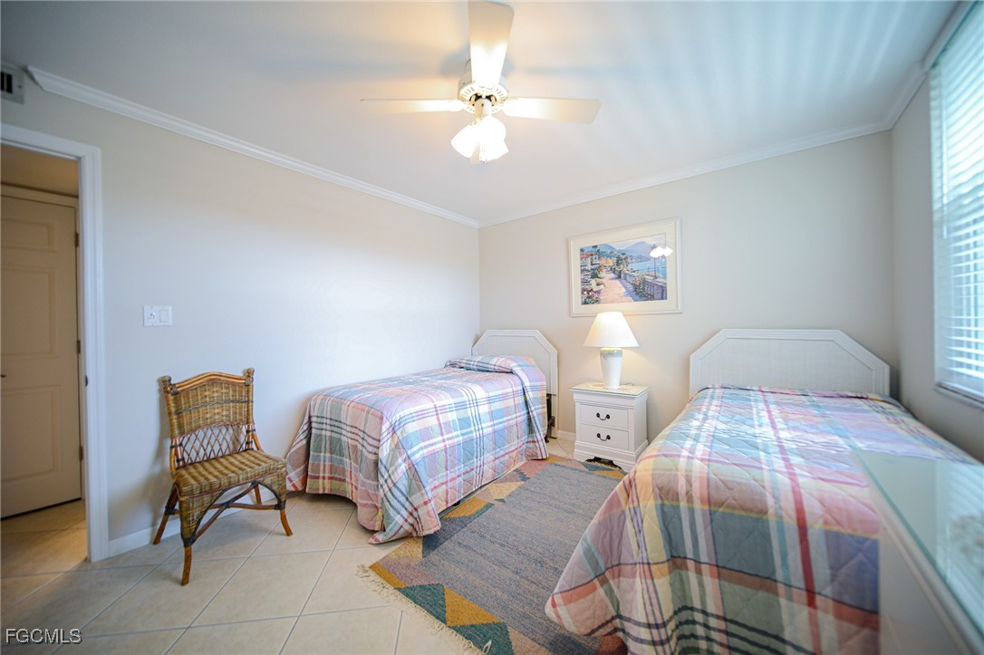 5959 Winkler Road, Unit 206 Fort Myers, FL 33919 - Photo 18 of 50 a bedroom with two beds and a chair