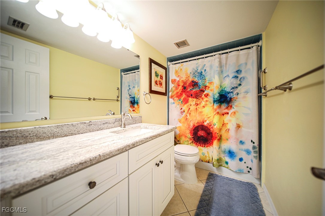 5959 Winkler Road, Unit 206 Fort Myers, FL 33919 - Photo 20 of 50 a bathroom with a granite countertop sink mirror vanity and toilet