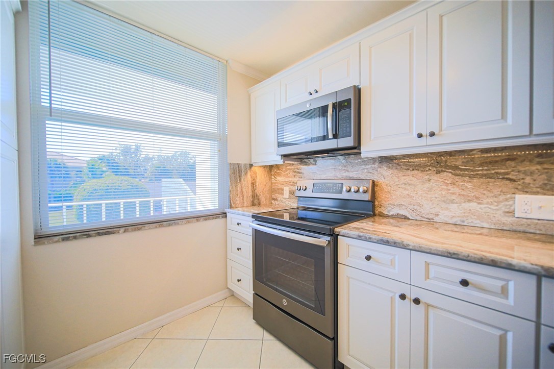 5959 Winkler Road, Unit 206 Fort Myers, FL 33919 - Photo 2 of 50 a kitchen with stainless steel appliances granite countertop a sink and a microwave