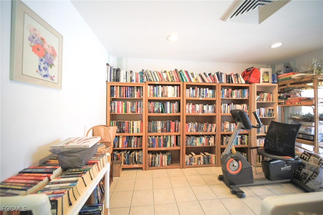 5959 Winkler Road, Unit 206 Fort Myers, FL 33919 - Photo 28 of 50 a living room with furniture cabinets and a book shelf