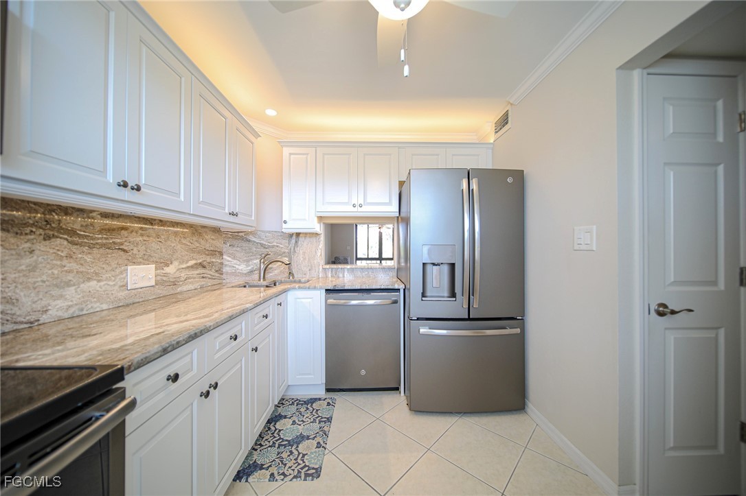 5959 Winkler Road, Unit 206 Fort Myers, FL 33919 - Photo 3 of 50 a kitchen with granite countertop a refrigerator and a sink