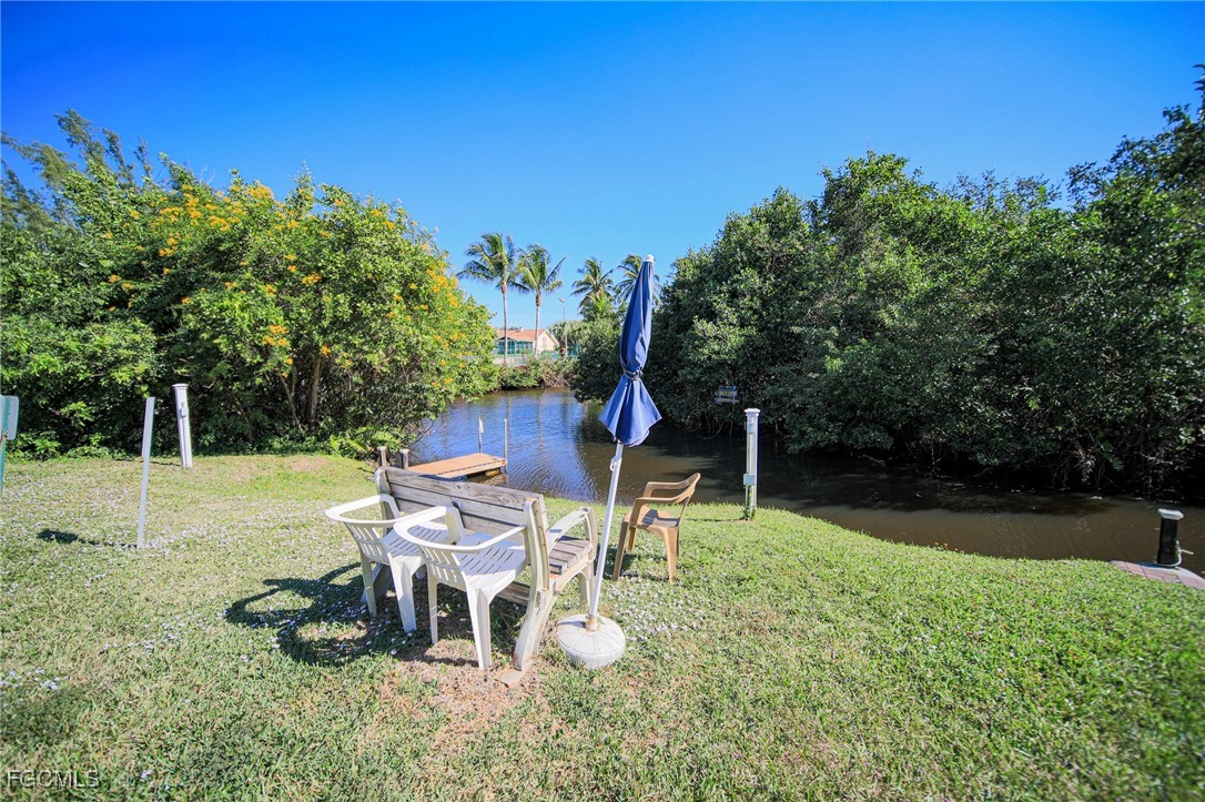 5959 Winkler Road, Unit 206 Fort Myers, FL 33919 - Photo 36 of 50 a backyard of a house with table and chairs