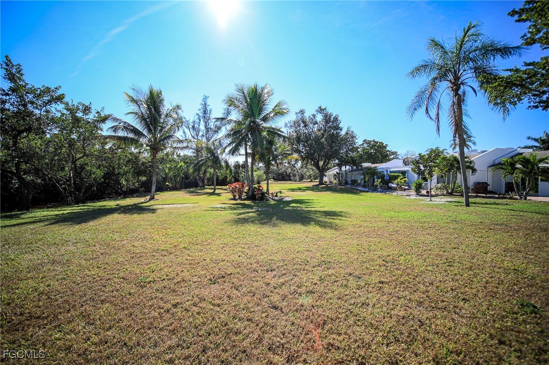 5959 Winkler Road, Unit 206 Fort Myers, FL 33919 - Photo 39 of 50 a view of a swimming pool with a yard and palm trees
