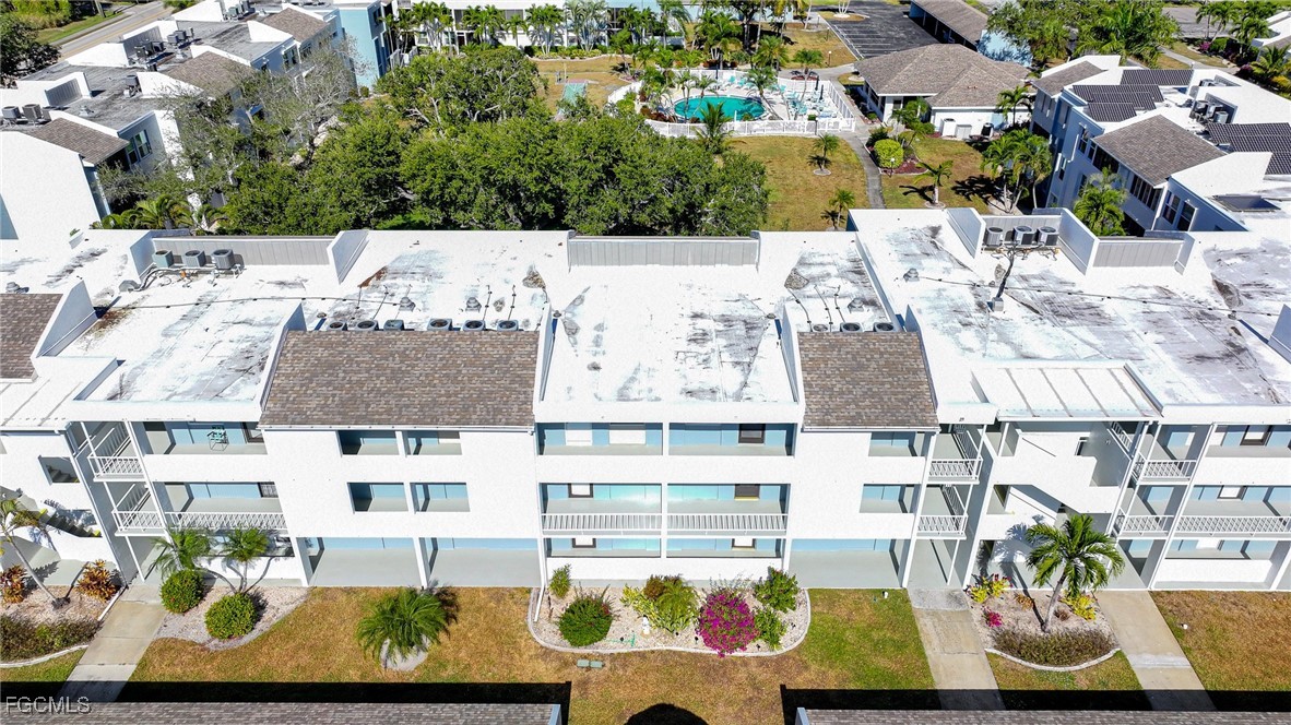 5959 Winkler Road, Unit 206 Fort Myers, FL 33919 - Photo 48 of 50 an aerial view of residential houses with outdoor space and swimming pool