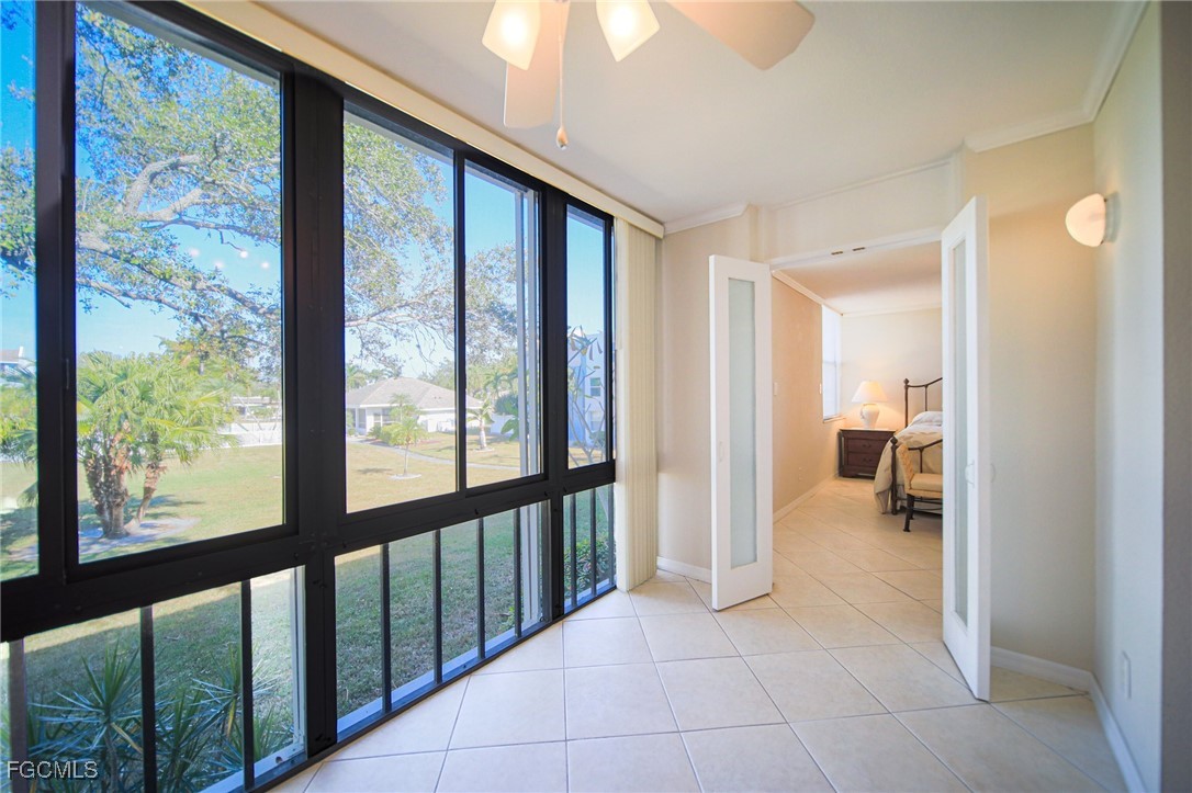 5959 Winkler Road, Unit 206 Fort Myers, FL 33919 - Photo 8 of 50 a view of a hallway with wooden floor and a chandelier