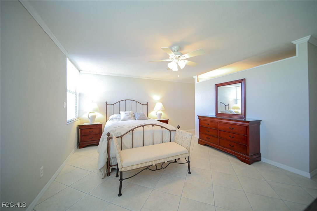 5959 Winkler Road, Unit 206 Fort Myers, FL 33919 - Photo 10 of 50 a bedroom with a bed and a chandelier